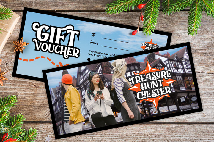 A gift voucher for Treasure Hunt Chester on a table covered with Christmas decorations