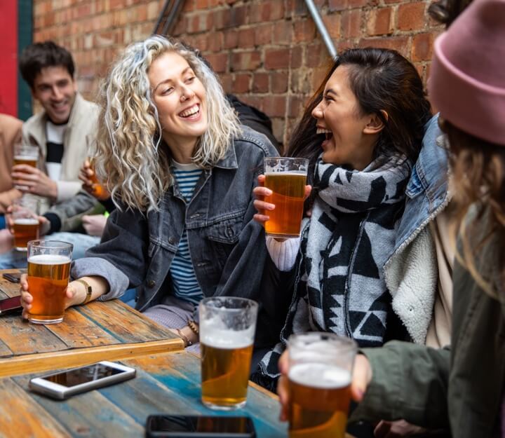 Friends enjoying a drink together while playing Treasure Hunt Chester